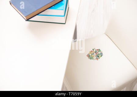 Office prank with sharp thumbtacks on chair Stock Photo