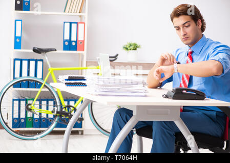 Young businessman using bike to commute to the office Stock Photo