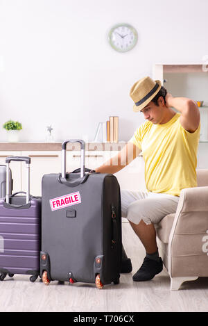 Man going on vacation with fragile suitcases Stock Photo