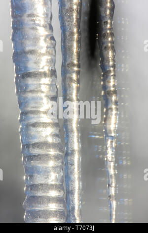 Roof with icicles hanging from roof. Stock Photo