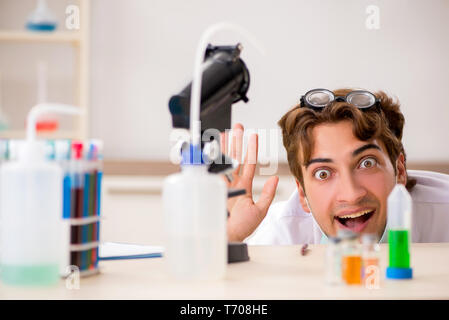 The funny crazy chemist doing experiments and tests Stock Photo