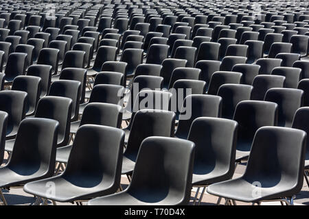 Rows of empty black plastic seats Stock Photo