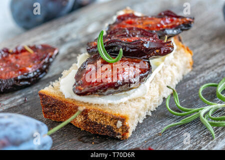 Appetizer of homemade bread and spicy dried plums. Stock Photo