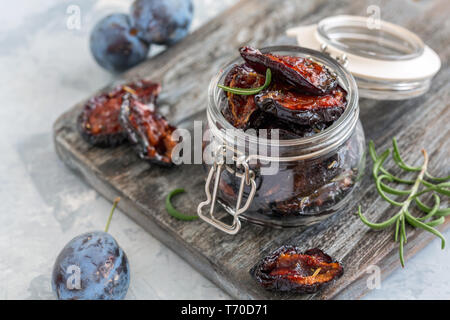 Glass jar with dried plums close-up. Stock Photo