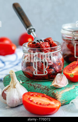 Sun-dried tomatoes with garlic, spices and olive oil. Stock Photo