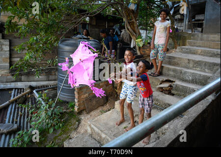 Children flying a kite in a residential area of Kandy, Sri Lanka Stock Photo