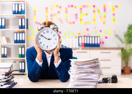Young employee suffering from excessive work Stock Photo