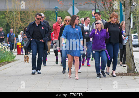 A group of people walking for gender equality during a Walk a Mile in Her Shoes campaign. Stock Photo