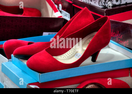 Red suede high heels used in a Walk a Mile in Her Shoes campaign to raise awareness for gender equality. Stock Photo