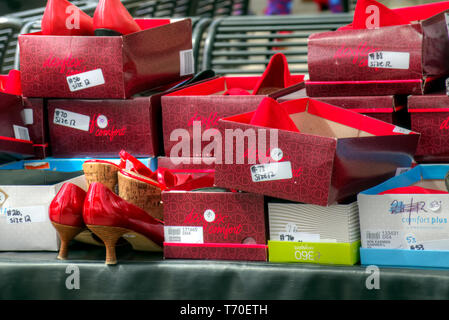 Boxes of red high heels to be worn by men supporting a Walk a Mile in Her Shoes campaign to raise awareness for gender equality. Stock Photo