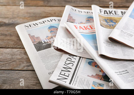 Newspapers on wooden background Stock Photo