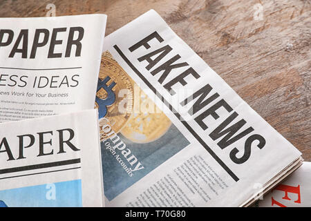 Newspapers on wooden background Stock Photo