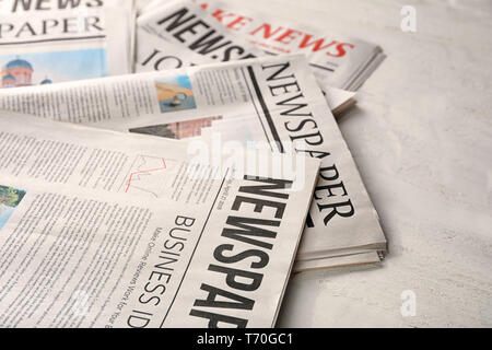 Newspapers on white wooden background Stock Photo