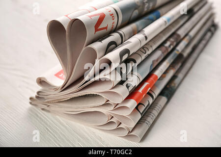 Newspapers on white wooden background Stock Photo