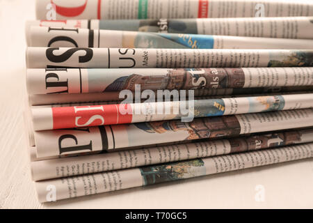 Newspapers on white wooden background Stock Photo