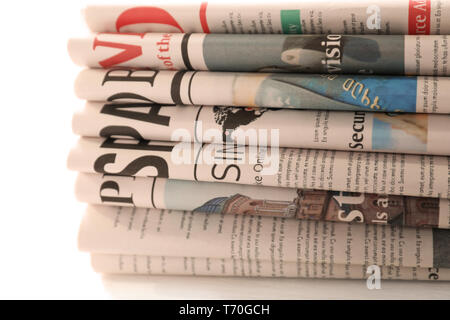 Pile of newspapers on white background Stock Photo