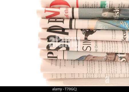 Pile of newspapers on white background Stock Photo