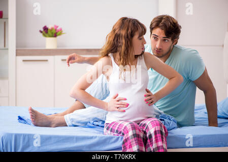 Pregnant woman with husband in the bedroom Stock Photo
