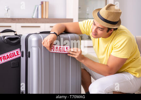 Man going on vacation with fragile suitcases Stock Photo