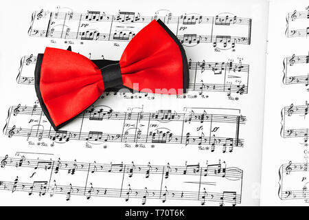 Red bow tie on music sheet Stock Photo