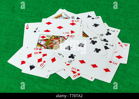 Casino playing cards on green table Stock Photo