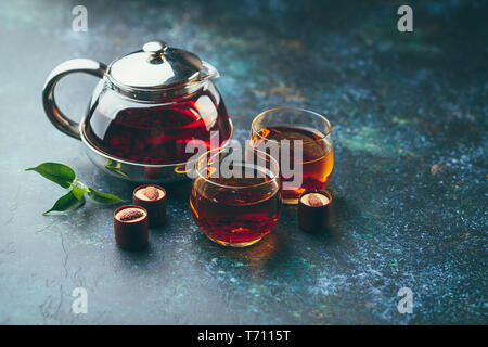 Glass cups of tea and teapot on the table Stock Photo