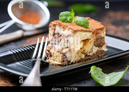 Piece of homemade Italian tiramisu dessert. Stock Photo