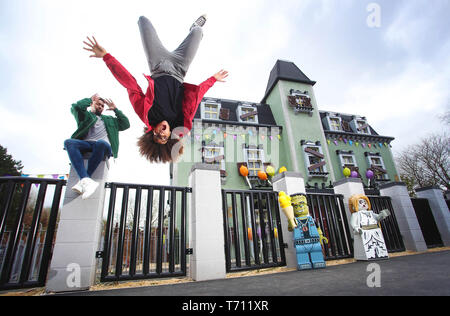Hair-raising flips and tricks from dancing Diversity duo Jordan Banjo (26) and Perri Kiely (23). The pair were invited down to the LEGOLAND® Windsor Resort for a sneak peek of the new ride – The Haunted House Monster Party – ahead of its grand opening on 13 April 2019.  Whilst at LEGOLAND, the boys – who are no strangers to spending time flipped upside down as part of their impressive dance careers – showed off their gravity-defying skills and signature party tricks around the Resort as it prepares for the ride’s opening. They were spotted performing flips outside the front of the Haunted Hous Stock Photo