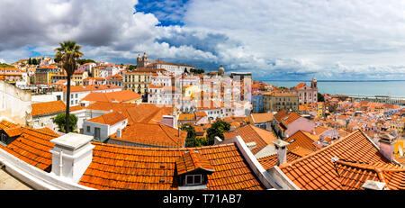 Lisbon, Portugal city skyline over the Alfama district. Summertime sunshine day cityscape in the Alfama, historic old district Alfama in Lisbon, Portu Stock Photo