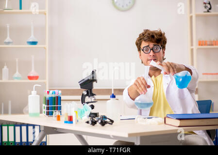 Funny crazy chemist doing experiments and tests Stock Photo