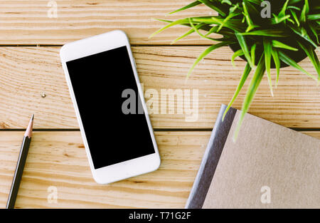 Blank screen smartphone on wooden table Stock Photo