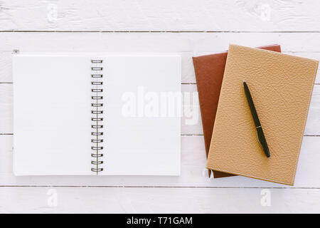 Open blank notepad with empty white pages on wooden table Stock Photo