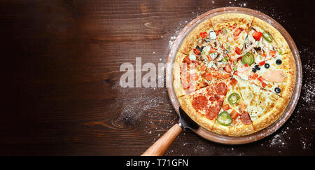 mix of eight different pizzas on a wooden background. menu concept of choice and diversity Stock Photo