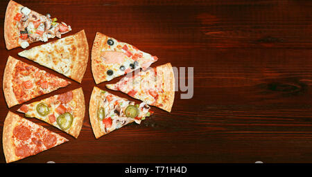mix of eight different pizzas on a wooden background. menu concept of choice and diversity Stock Photo