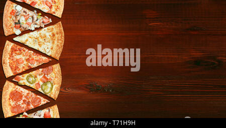 mix of eight different pizzas on a wooden background. menu concept of choice and diversity Stock Photo