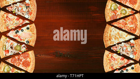 mix of eight different pizzas on a wooden background. menu concept of choice and diversity Stock Photo
