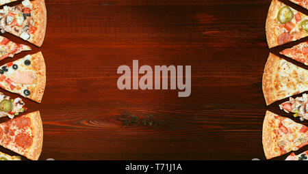 mix of eight different pizzas on a wooden background. menu concept of choice and diversity Stock Photo