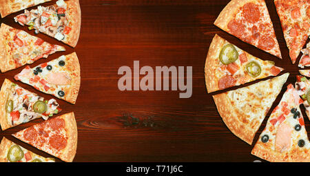 mix of eight different pizzas on a wooden background. menu concept of choice and diversity Stock Photo