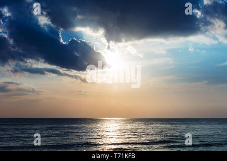 sunset over ocean and clouds Stock Photo