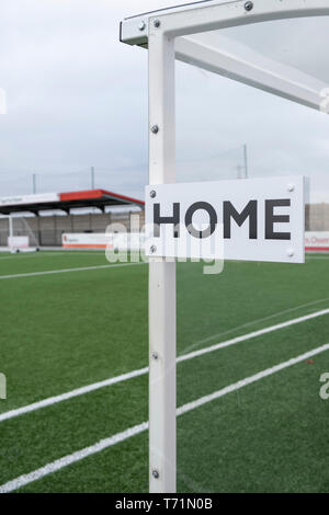 A empty football ground with satnds and home team dug out. Stock Photo