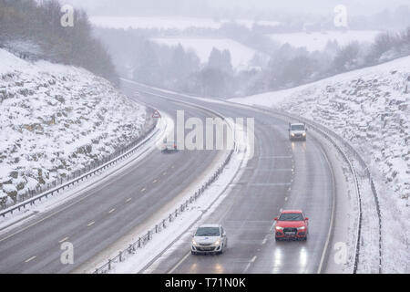A view of the A419 / A417 by pass with vehicles travelling very slowly in the dangerous road conditions, pictured after a heavy winter snowfall the road that heads through the heart of the Cotswolds in the UK is barely passable in these unusally bad conditions for travelling in. Stock Photo