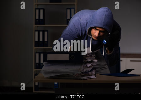 Thief trying to steal personal data in identity theft concept Stock Photo