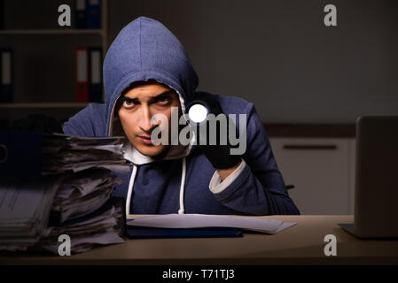 Thief trying to steal personal data in identity theft concept Stock Photo