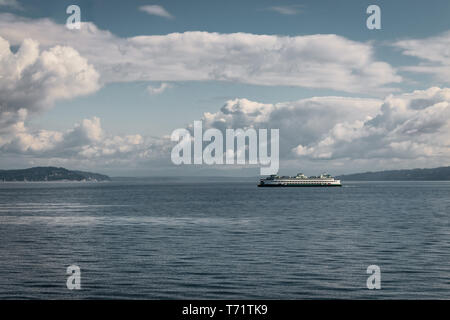 The ferry Walla Walla makes its way on a cloudy summer day from Bainbridge Island to Seattle in the Puget Sound, Washington state. Stock Photo