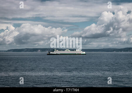 The ferry Walla Walla makes its way on a cloudy summer day from Bainbridge Island to Seattle in the Puget Sound, Washington state. Stock Photo