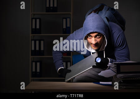 Thief trying to steal personal data in identity theft concept Stock Photo