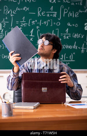Funny male math teacher in the classroom Stock Photo - Alamy