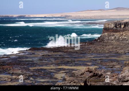 Stunning natural viewpoint with amazing rugged cliffs, turquoise water and the ferocity of the sea at north-west coast of Fuerteventura, Canary Island Stock Photo