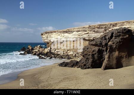 Sharp rugged cliff and rocks on isolated secluded beach at north-west coast of Fuerteventura, Canary Islands, Spain Stock Photo