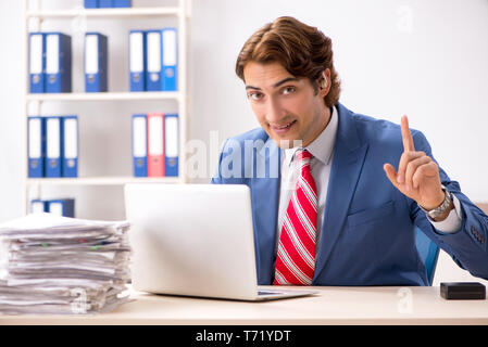 Deaf employee using hearing aid in office Stock Photo